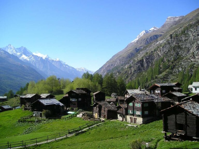 Rustic mountain village with wooden chalets and scenic mountain backdrop