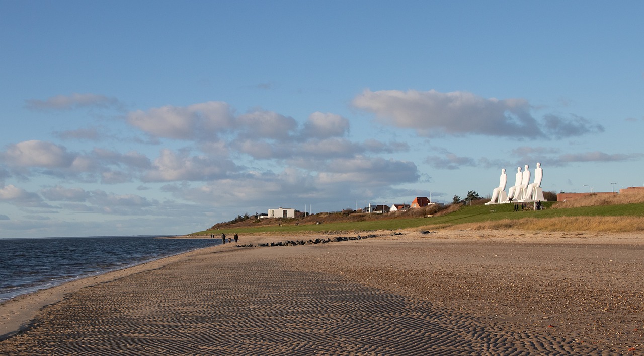 Sitting men sculptures at Esbjerg beach in denmark