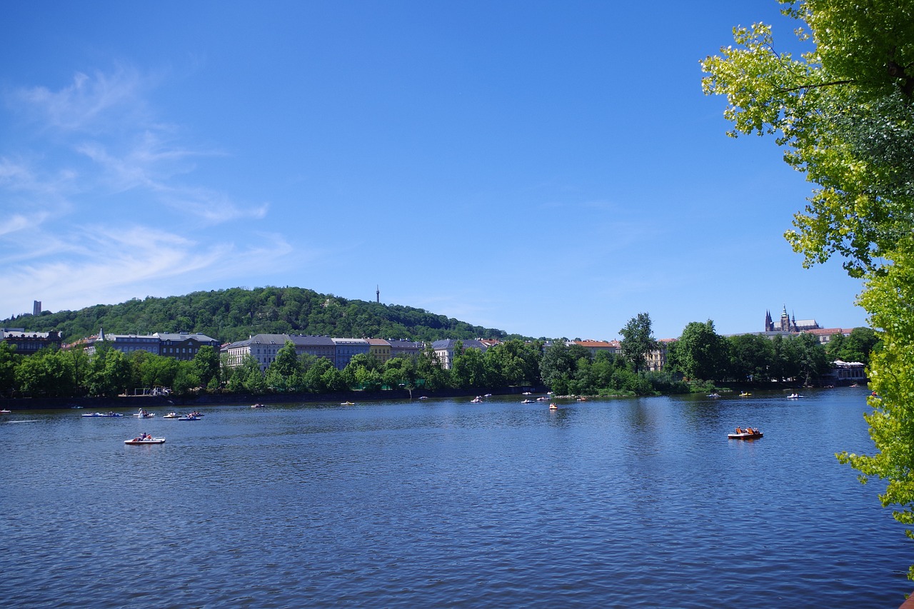 Moldau river with boats and trees in the background close to Prague