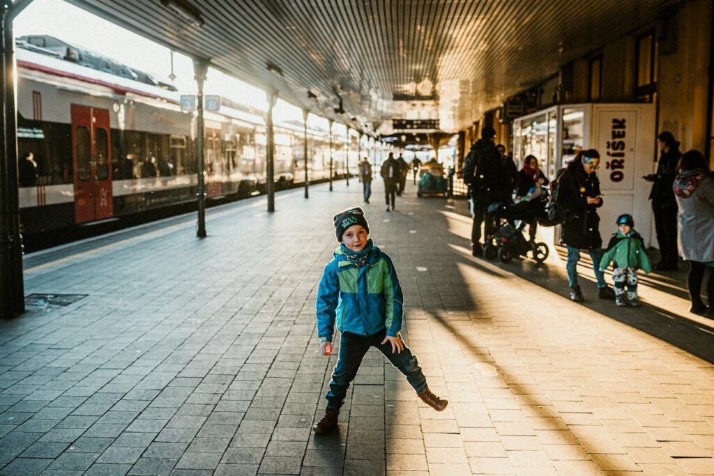 family with happy kid leaving for vacation at a train station