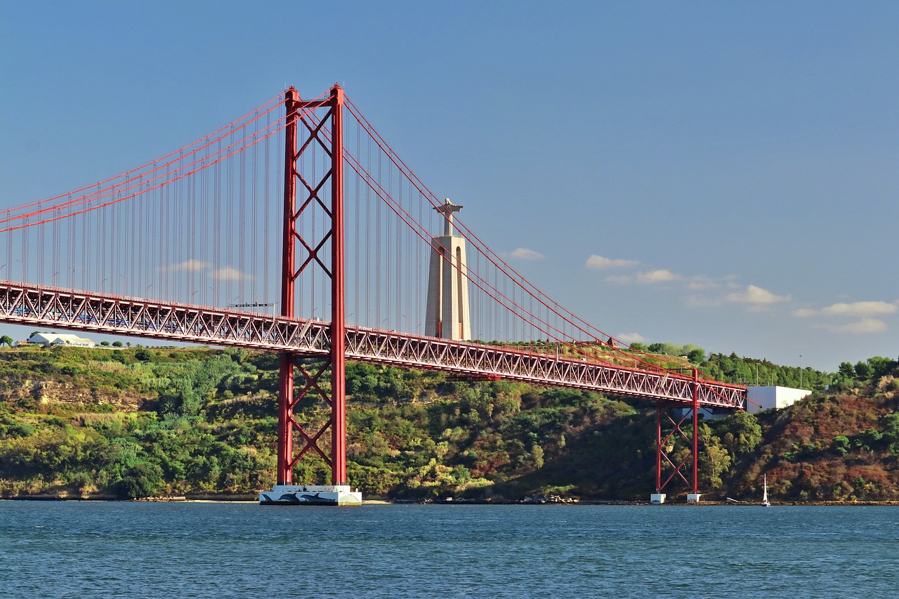 25th of April Bridge in Lissabon in Portugal with the Jesus statue in the back