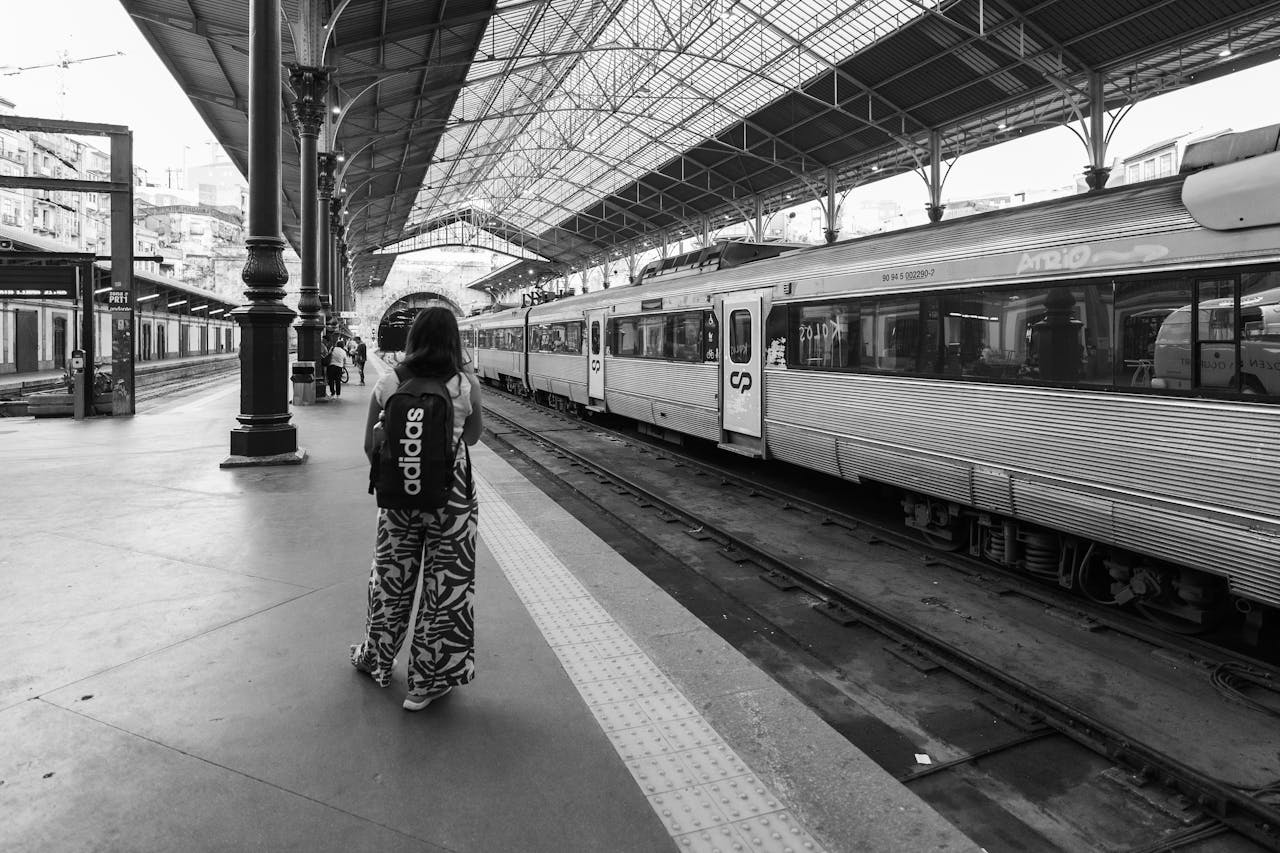 Train station in Porto with CP Trains and a girl waiting