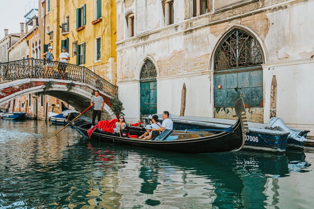 family on a gondola going through the canals of Venice