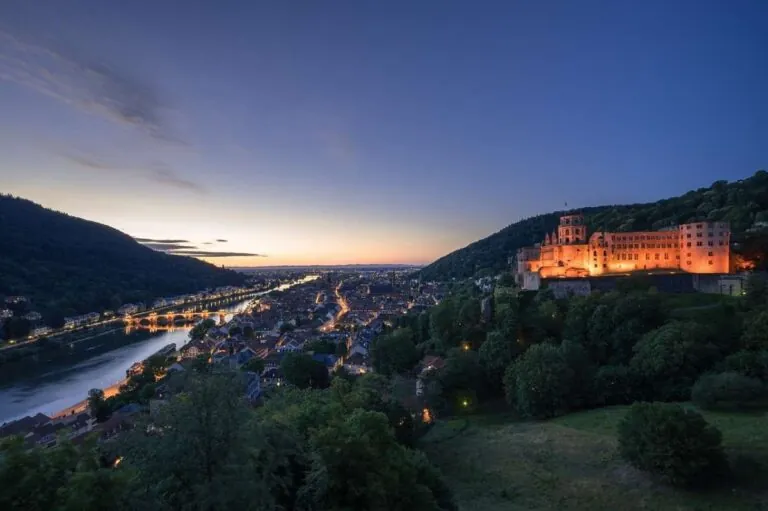 Heidelberg Castle lit up at night, overlooking the river