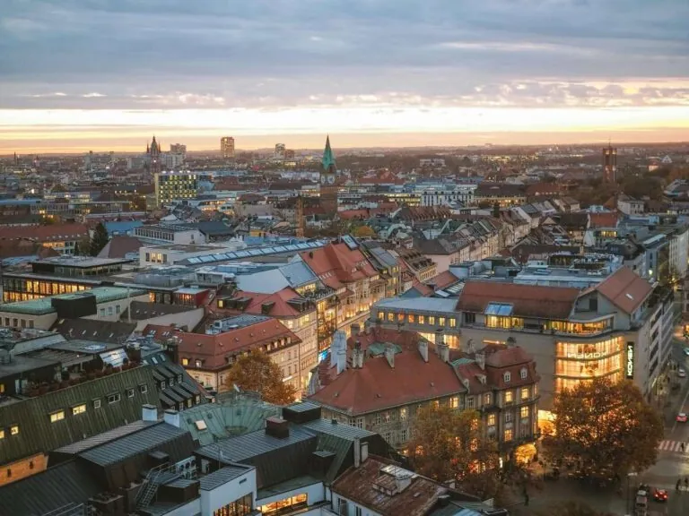 Sunset view of Munich cityscape with red-roofed buildings