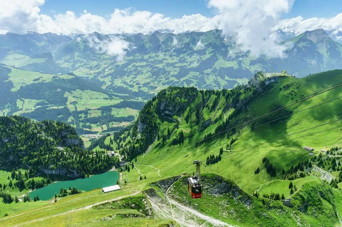 Cable car over lush green mountains with a scenic valley view