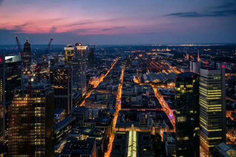 Frankfurt skyline at dusk with skyscrapers and illuminated streets below