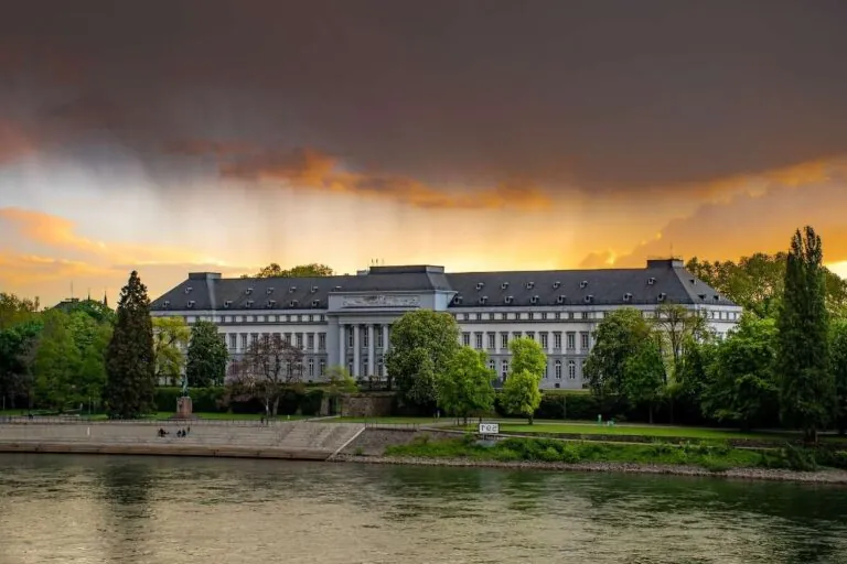 Classic riverside castle in Koblenz with cloudy skies at sunset