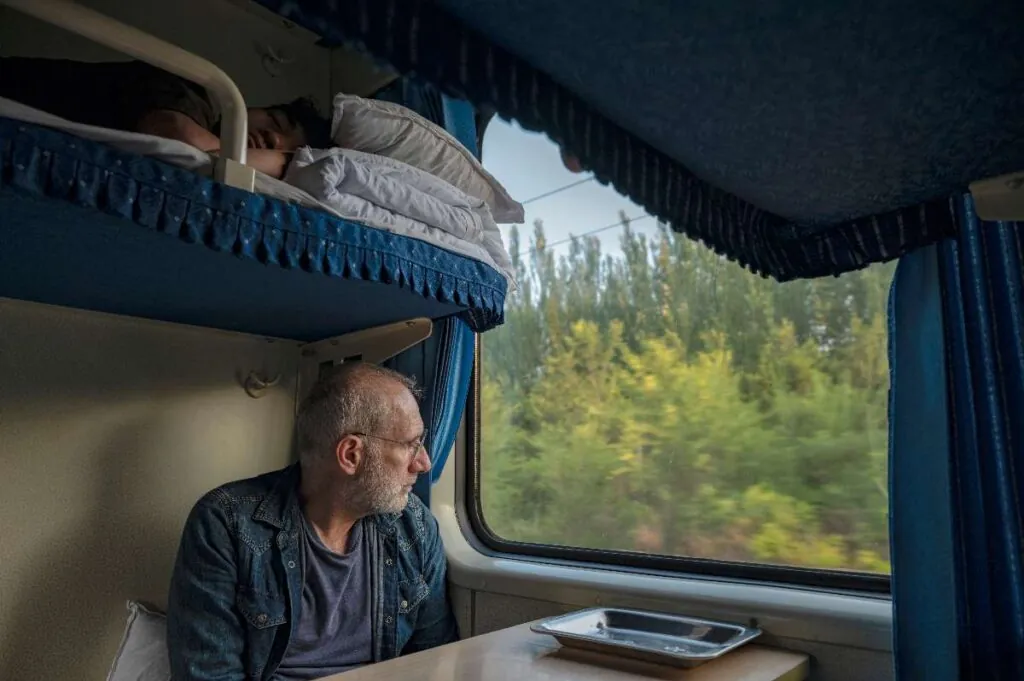 department in a night train with a man looking out of the window